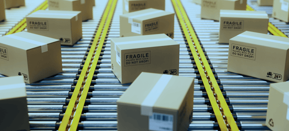 Image of boxes on conveyor belt,banner for Routeique blog on responding to increased demand
