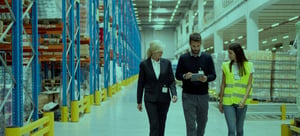 Blog cover image of team members in a warehouse, for blog of essential factors to consider choosing a warehouse