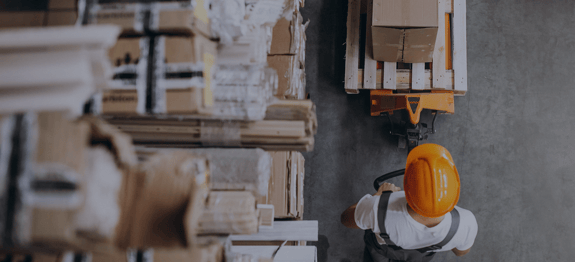 Banner image of person pulling pallet in warehouse, for Routeique blog on Warehouse Optimization For B2B and B2C