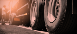 Image of truck wheels, banner image for Routeique blog on driver shortage